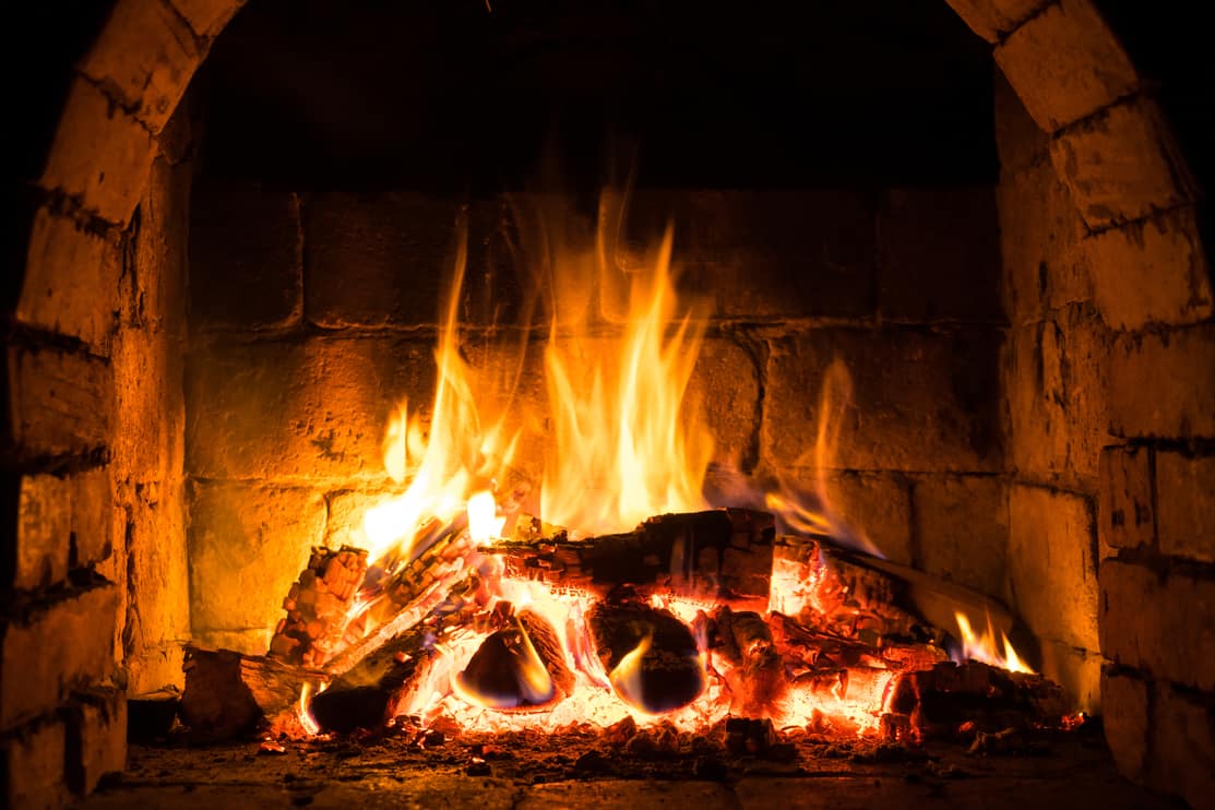 Wood burning in a cozy fireplace at home, keep warm. texture